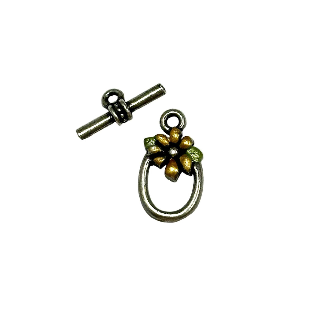 Metal toggle clasp with floral design on a white background