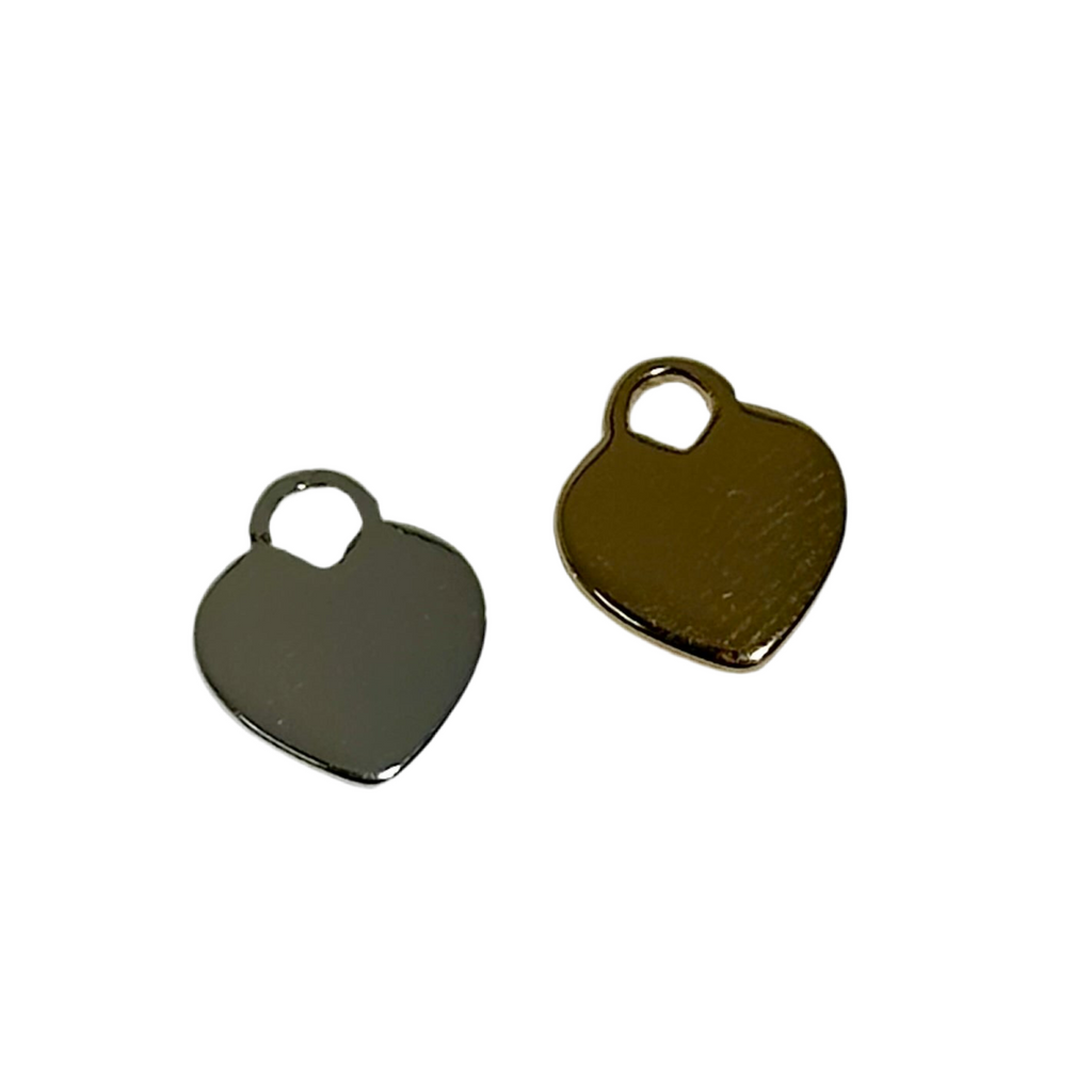 Two heart-shaped metal tags, one silver and one gold, on a white background.