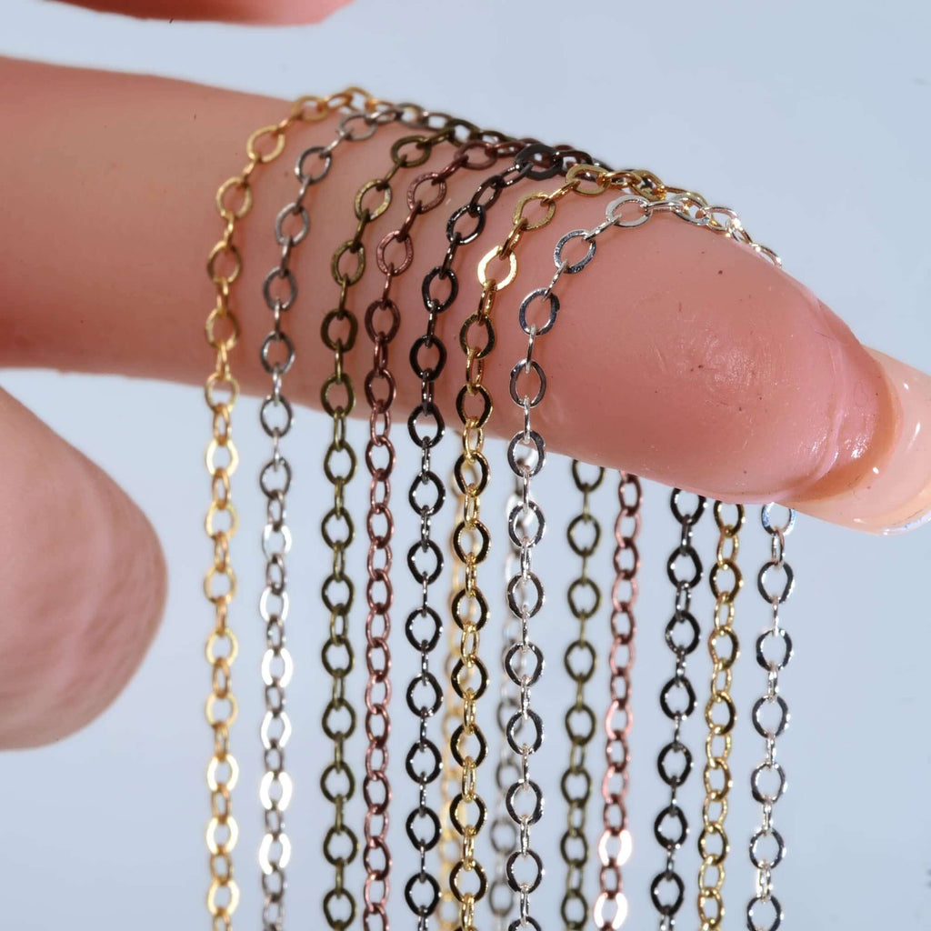 Multiple colors of 2mm cable chain displayed on a finger, showcasing gold, silver, and rose gold finishes.